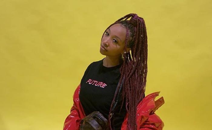 Zonnique pose for a picture for a promotional post.